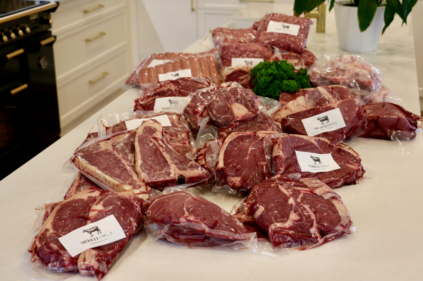 Vacuum-sealed assorted beef cuts spread on a kitchen counter for an 80kg beef box
